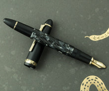 Load image into Gallery viewer, The fountain pen barrel resting on the cap.