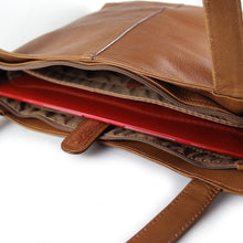 Load image into Gallery viewer, Top view of the leather tote bag with a laptop tucked inside.