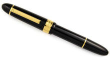 Load image into Gallery viewer, Front view of the fountain pen with the cap on. It features a black body and cap with golden accents.