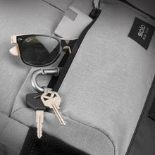Load image into Gallery viewer, The front pocket unzipped with a pair of keys and some sunglasses peeking from inside.