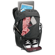Load image into Gallery viewer, Angled front view of the backpack with clothes, electronics, and a pair of shoes organized in the compartments.