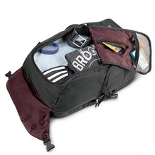 Load image into Gallery viewer, The backpack laid on the back panel, showing the main compartment unzipped and filled with clothes and travel accessories.