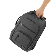 Load image into Gallery viewer, A hand holding the backpack by the top panel's grab handle.
