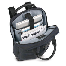 Load image into Gallery viewer, Angled top panel view with a magazine and electronics organized in the pockets.