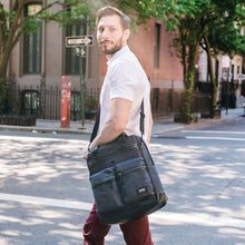 Load image into Gallery viewer, A young man carrying the briefcase with the shoulder strap.