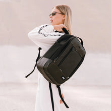 Load image into Gallery viewer, A young woman wearing a white outfit carrying the backpack.