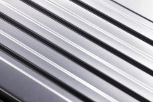 Load image into Gallery viewer, Close up to the front panel of the suitcase's ridged pattern.