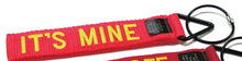 Load image into Gallery viewer, Red luggage tag with yellow embroidered text: IT'S MINE