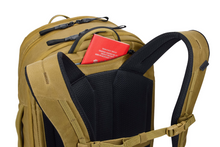 Load image into Gallery viewer, Close up to the back panel's top. A passport is tucked in the pocket between the shoulder straps.