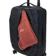 Load image into Gallery viewer, Angled front panel view of the suitcase with a folded sweater tucked into the front pocket.
