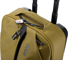 Load image into Gallery viewer, Angled top panel view of the suitcase, showing the front pocket and the main compartment closed with a three-digit TSA approved padlock.