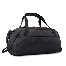 Load image into Gallery viewer, Angled front panel view of the black duffle bag showing the shoulder strap attached.