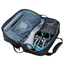 Load image into Gallery viewer, Interior view of the black duffle bag with clothes and electronics organized in the compartments.