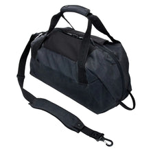 Load image into Gallery viewer, Angled view of the black duffle bag with the shoulder strap detached from one side.