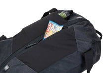 Load image into Gallery viewer, Angled top view of the duffle bag with a granola bar and a water bottle tucked inside the top panel's pockets.