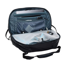 Load image into Gallery viewer, Interior view of the black duffle bag with the pockets filled with clothes and electronics.