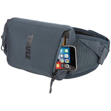 Load image into Gallery viewer, Angled front panel view of the hip pack showing a phone tucked in the front pocket.