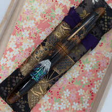 Load image into Gallery viewer, Front view of the fountain pen with the cap on. It rests on top of the kimono case.