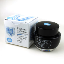 Load image into Gallery viewer, The light washed ink bottle with its box on a white background. It is a sky blue color.