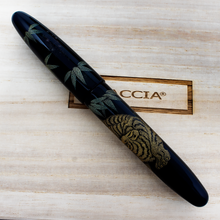 Load image into Gallery viewer, Side view of the fountain pen with the cap on. Placed on top of the wooden box.