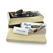 Load image into Gallery viewer, The fountain pen arranged with the boxes, kimono sleeve, cards, and ink cartridges.