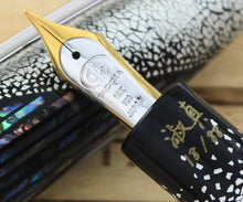 Load image into Gallery viewer, Close up to the engraved nib with the Taccia logo and text: 18K, 750, Japan.
