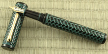 Load image into Gallery viewer, Front view of the fountain pen resting on the cap.