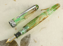 Load image into Gallery viewer, Front view of the fountain pen with the cap set to the side.