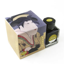 Load image into Gallery viewer, The Natane ink bottle and box on a white background. It is a gold-yellow tone.