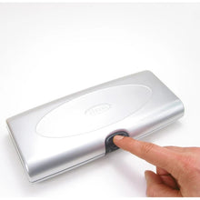 Load image into Gallery viewer, Angled front view of the silver case with a hand pressing the case's button.