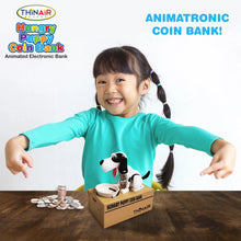 Load image into Gallery viewer, A child smiling while pointing at the puppy coin bank with a pile of coins next to it.