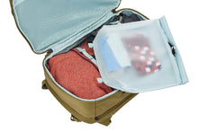 Load image into Gallery viewer, Interior view of the backpack filled with clothes and travel accessories.