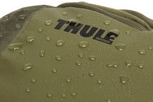 Load image into Gallery viewer, Close up to the Thule logo on the front panel with water droplets sprayed across the fabric, featuring its water resistant material.