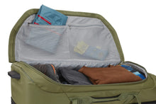 Load image into Gallery viewer, Interior view of the wheeled duffle bag with clothes and travel accessories arranged in the compartments.