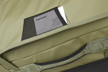 Load image into Gallery viewer, Close up to a small pocket on the side panel, holding a business card.