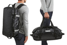 Load image into Gallery viewer, Two images showing the duffle's carrying options: Via the shoulder straps, and by the grab handles.