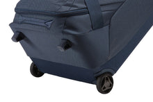 Load image into Gallery viewer, Angled bottom panel view of the dress blue duffle. It features the two back wheels, and two stub legs to stand the duffle up.