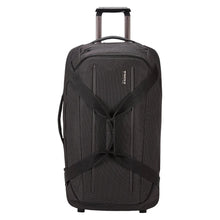 Load image into Gallery viewer, Front panel view of the wheeled duffle bag with the telescopic handle extended.
