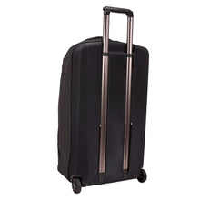 Load image into Gallery viewer, Angled back panel view of the black wheeled duffle. The back panel is made poly-carbonate to protect your items.