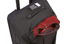 Load image into Gallery viewer, Angled top panel with a jacket peeking from a pocket.