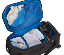 Load image into Gallery viewer, Angled view showing the main compartment unzipped and filled with clothes.