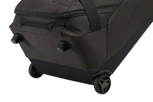 Load image into Gallery viewer, Angled bottom view showing the two wheels and two stub legs at the front to stand the duffle bag on its side .