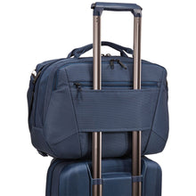 Load image into Gallery viewer, The duffel's back panel strap holding on to a suitcase's telescopic handle.