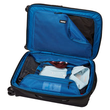Load image into Gallery viewer, Interior view of the suitcase with a set of folded clothes and travel accessories tucked in the compartments.