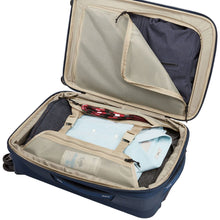 Load image into Gallery viewer, Interior view showing a set of clothes and travel accessories arranged in the main compartment and pockets.