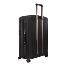 Load image into Gallery viewer, Angled back panel view of the suitcase with the telescopic handle partly extended.