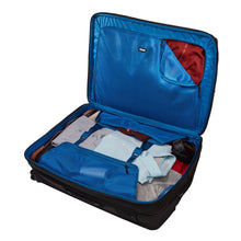 Load image into Gallery viewer, Interior view of the black suitcase with a set of clothes folded into the compartments.