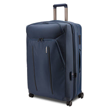 Load image into Gallery viewer, Angled front panel view of the blue suitcase with the telescopic handle partly extended.