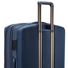 Load image into Gallery viewer, Angled back panel close up to the blue suitcase showing the telescopic handle partly extended.