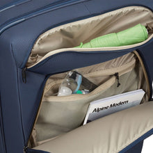 Load image into Gallery viewer, The front panel's pockets unzipped, shown holding toiletries and a magazine.